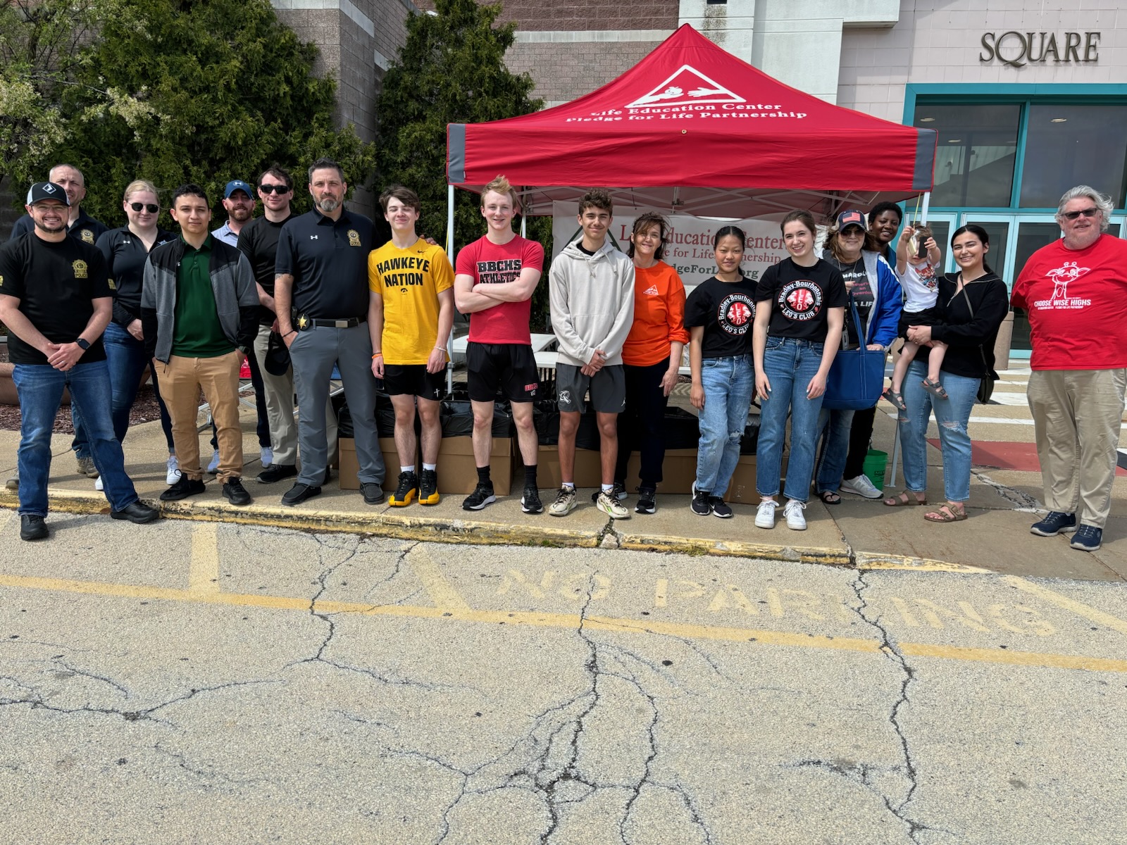 A group of people representing Pledge for Life Partnership in front of an educational stand