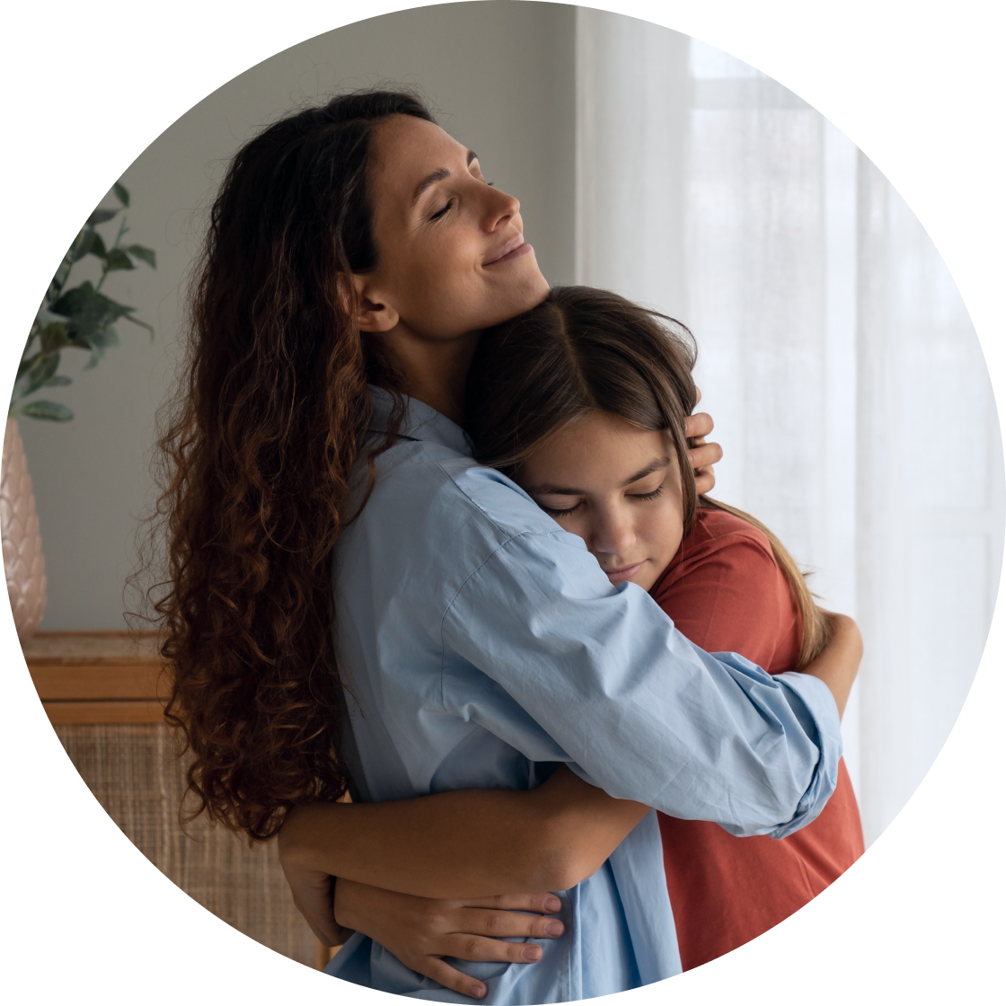 Mother hugging daughter